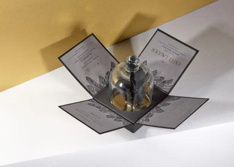 Estée Lauder boxed cloche invitation with paper feather sculpture